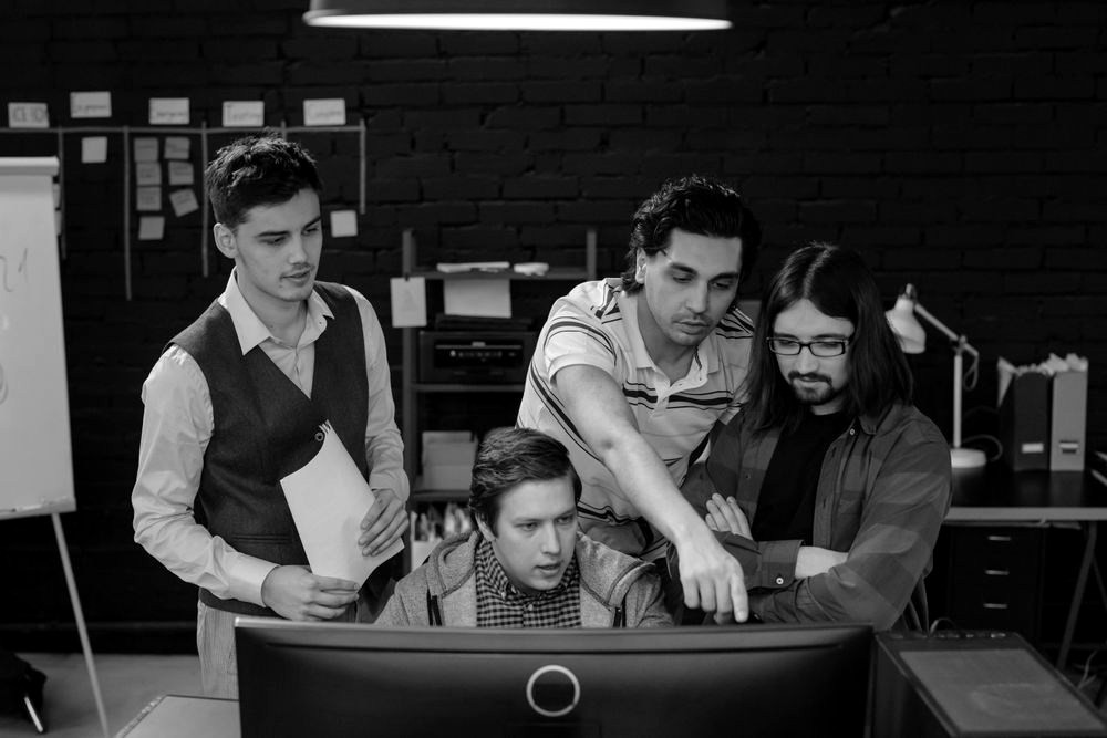Colleagues reviewing work together at a computer